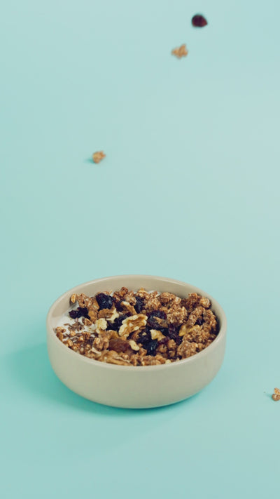 Versata di granola artigianale al farro Poggio del Farro su yogurt in una bowl